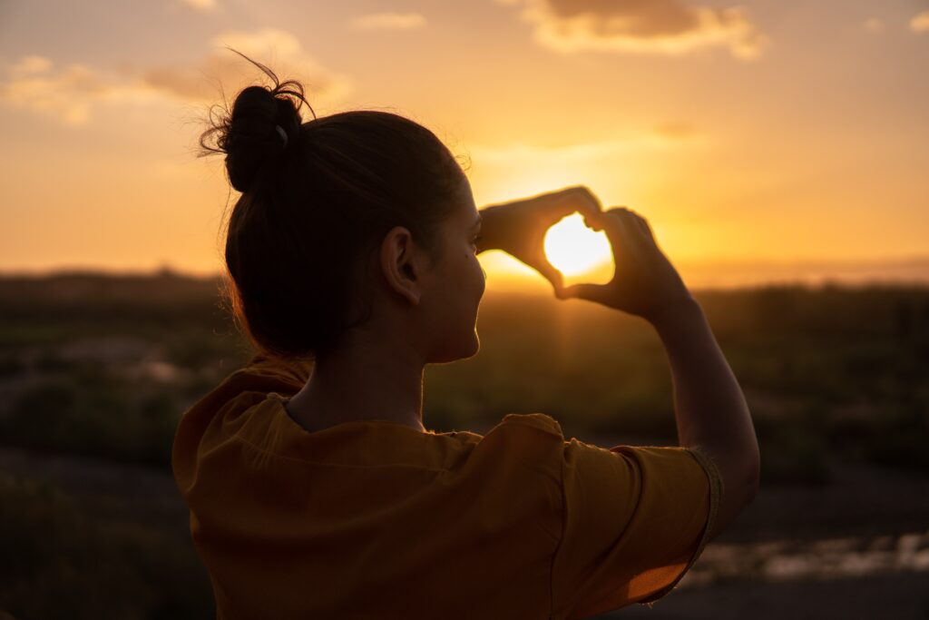 Photo by Hassan OUAJBIR from Pexels: https://www.pexels.com/photo/woman-doing-hand-heart-sign-1535244/